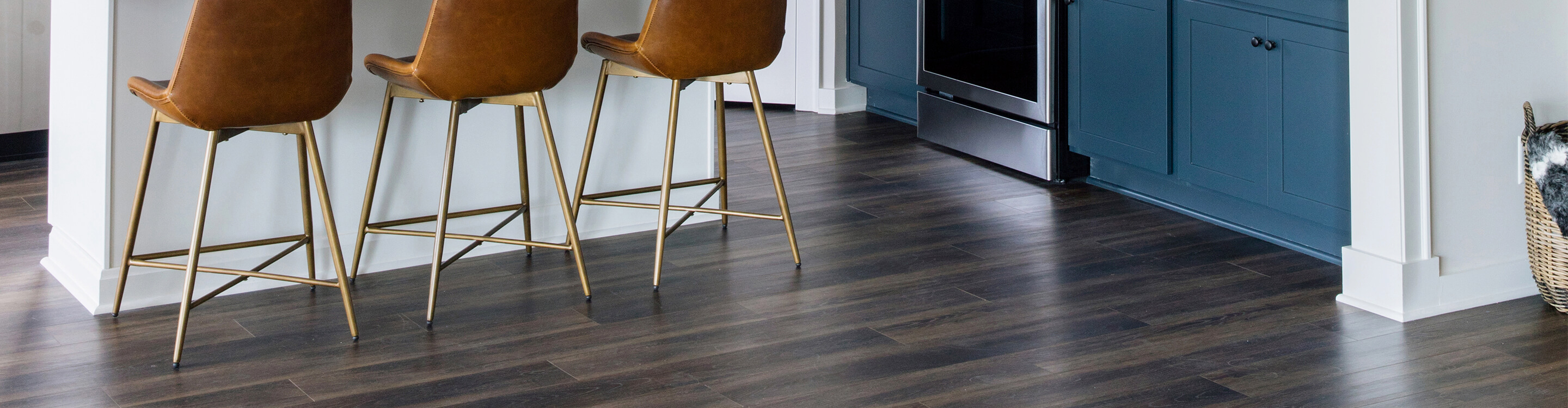 dark laminate flooring in kitchen with island and stools